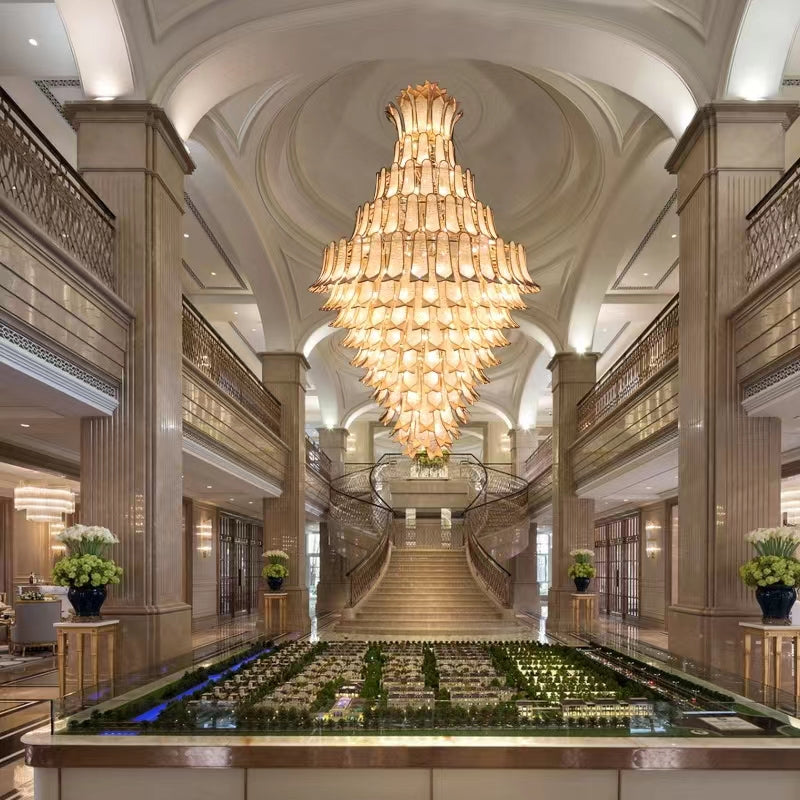 https://cdn.shopify.com/s/files/1/0736/8795/7790/files/extra-large-luxury-multi-tier-gold-crystalchandelier-for-stairslarge-high-ceiling-room-merlin-lamps-2.jpg?v=1765406231