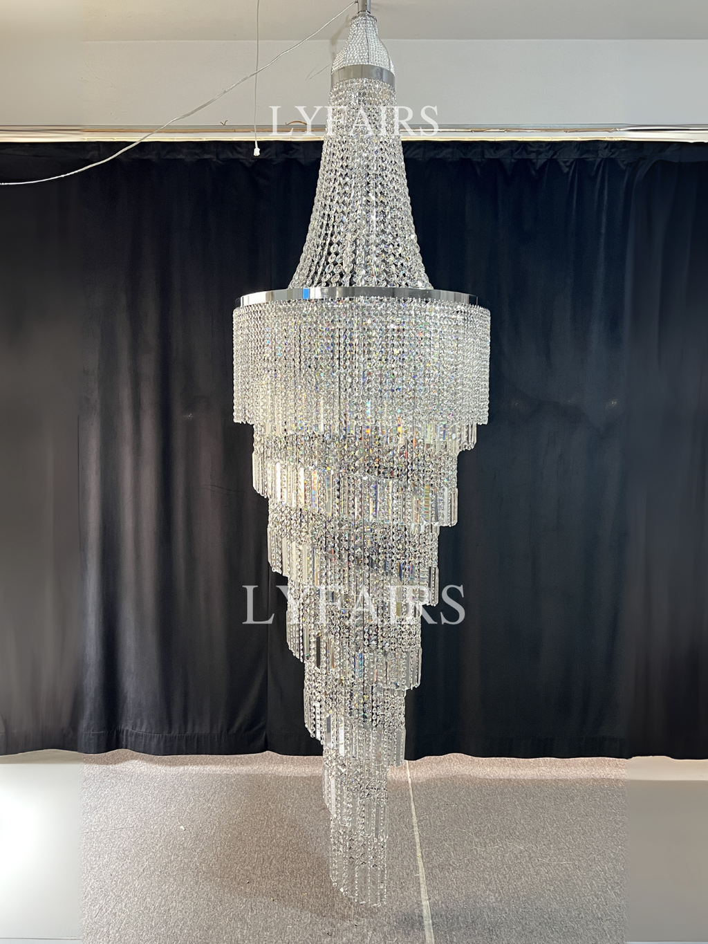 https://cdn.shopify.com/s/files/1/0554/8562/8591/files/lyfairsModernCrystalTasselChandelierforFoyerStaircase.png?v=1775619528