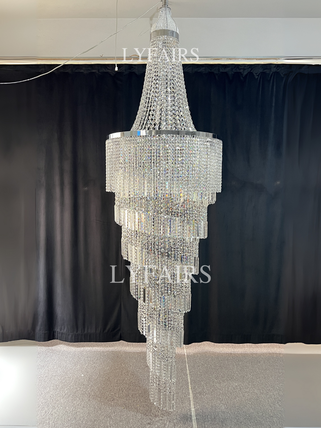 https://cdn.shopify.com/s/files/1/0554/8562/8591/files/lyfairsModernCrystalTasselChandelierforFoyerStaircase.png?v=1775619528
