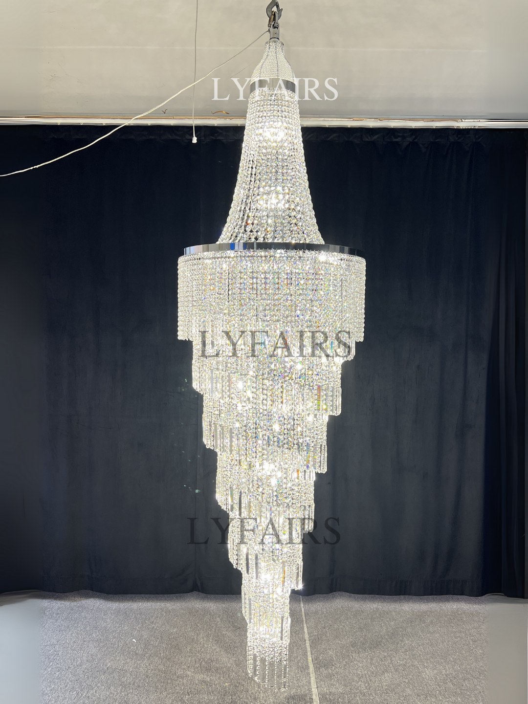 https://cdn.shopify.com/s/files/1/0554/8562/8591/files/lyfairsModernCrystalTasselChandelierforFoyerStaircase_1.png?v=1775619528