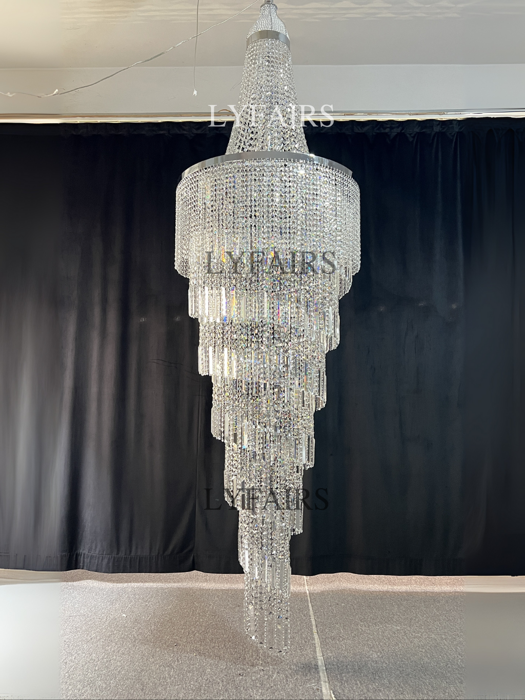 https://cdn.shopify.com/s/files/1/0554/8562/8591/files/lyfairsModernCrystalTasselChandelierforFoyerStaircase_2.png?v=1775619528