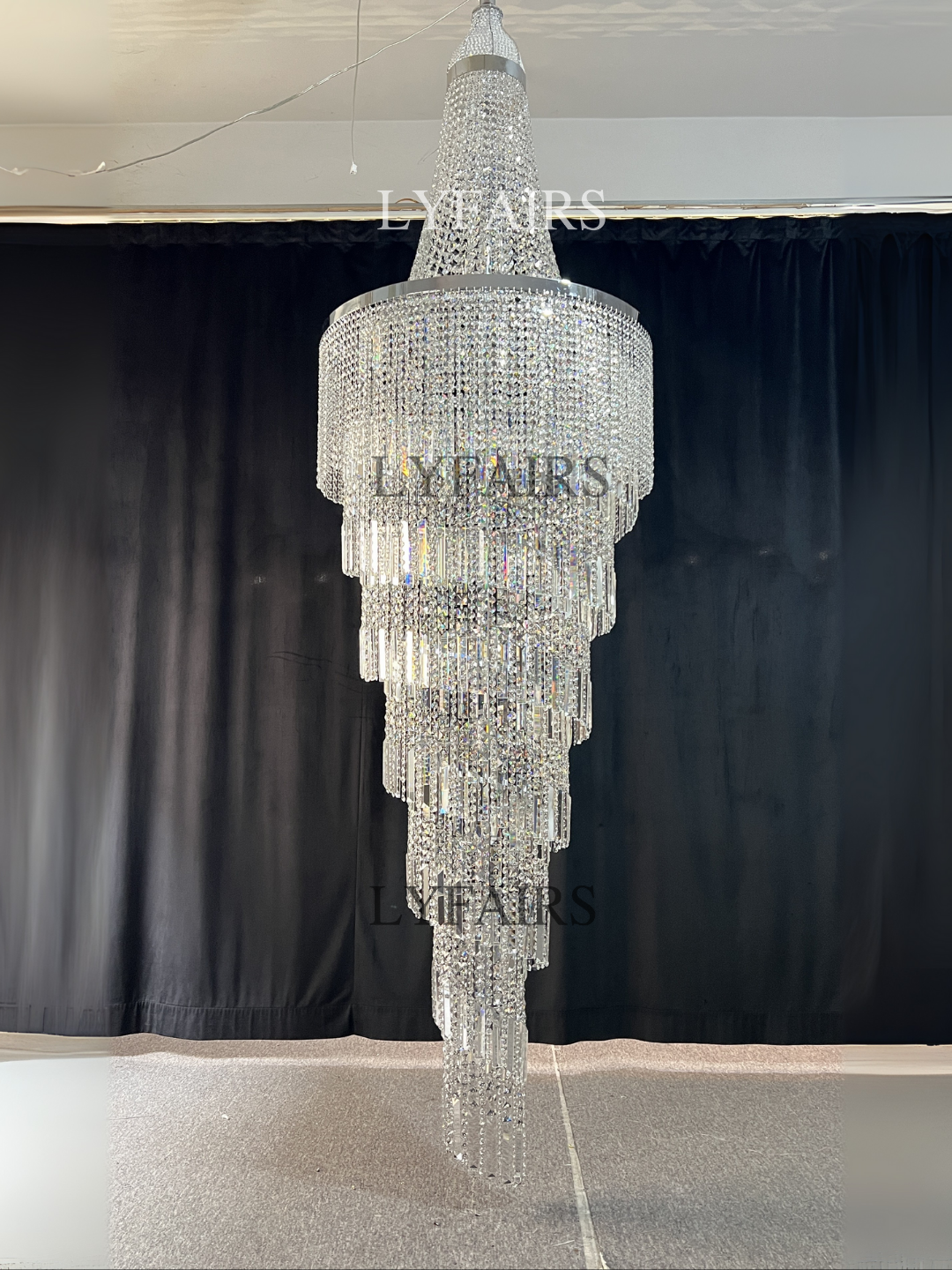 https://cdn.shopify.com/s/files/1/0554/8562/8591/files/lyfairsModernCrystalTasselChandelierforFoyerStaircase_2.png?v=1775619528