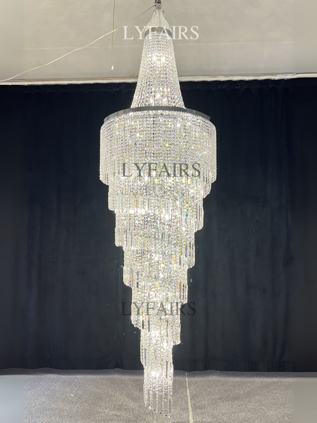 https://cdn.shopify.com/s/files/1/0554/8562/8591/files/lyfairsModernCrystalTasselChandelierforFoyerStaircase_3.png?v=1775619528