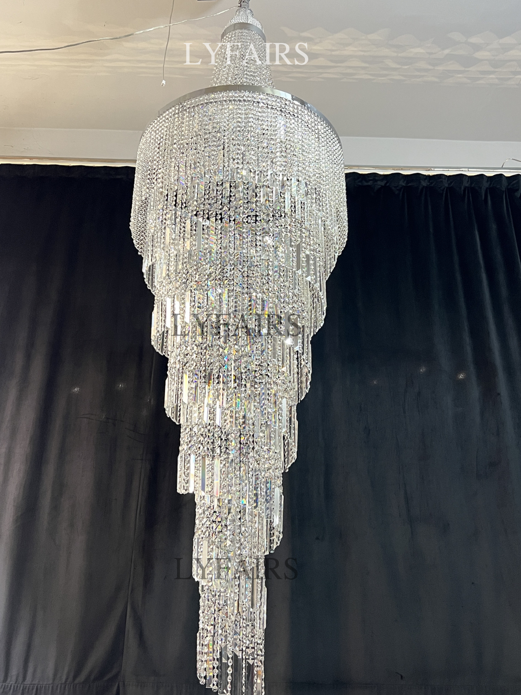 https://cdn.shopify.com/s/files/1/0554/8562/8591/files/lyfairsModernCrystalTasselChandelierforFoyerStaircase_4.png?v=1775619528