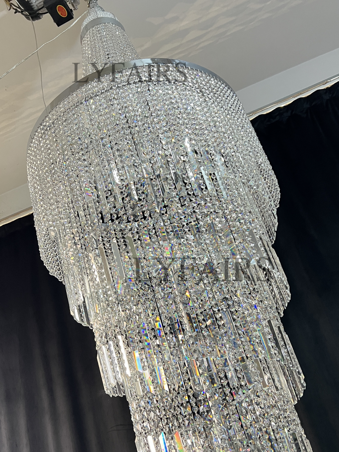 https://cdn.shopify.com/s/files/1/0554/8562/8591/files/lyfairsModernCrystalTasselChandelierforFoyerStaircase_8.png?v=1775619528