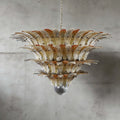 Amber glass Palmette chandelier shown in a large tiered studio view on a gray wall.