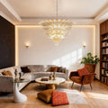 Clear glass Palmette chandelier above a living room seating area with a sofa.
