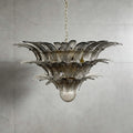 Smoky gray glass Palmette chandelier shown in a wider studio view on a gray wall.